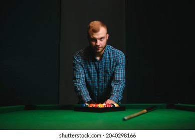 Young Man Playing Billiards In The Dark Billiard Club