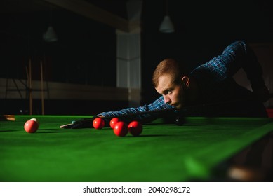 Young Man Playing Billiards In The Dark Billiard Club