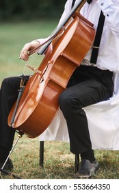 Young Man Playing Cello Outside. Cellist Playing Classical Music On Cello