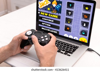 Young Man Playing Computer Games At Home