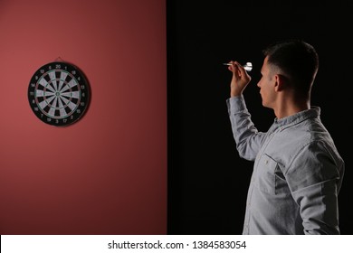 Young Man Playing Darts Indoors
