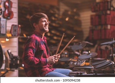 Young Man Playing Drums In The Store