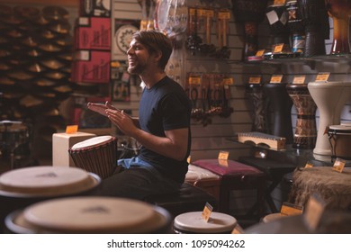 Young Man Playing Drums In The Store