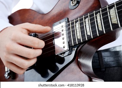 Young Man Playing Electric Guitar, Close Up