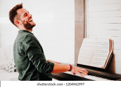 Young Man Playing Electric Piano At Home