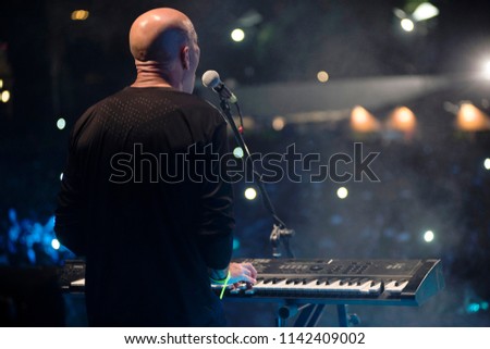 young man playing electronic keyboard.