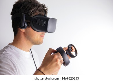 Young man playing games with virtual reality (VR) goggles