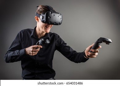 young man playing games with virtual reality goggles