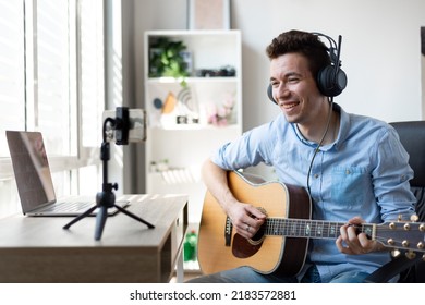 Young Man Playing Guitar, Musician Artist Recording New Song, Making Music In Home Studio, Using Laptop, Teacher Holding Online Lesson