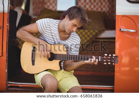 Similar – Young musician enjoying guitar on sunny day