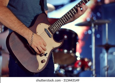 Young man playing on electric guitar close up - Powered by Shutterstock