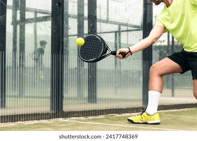 young man playing paddle tennis. close-up - Powered by Shutterstock