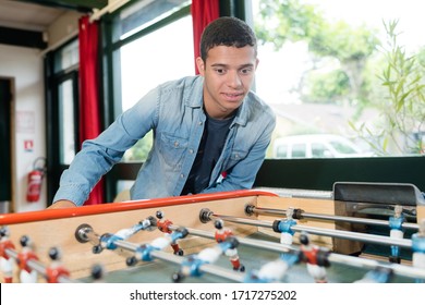 Young Man Playing Table Football