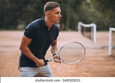 Young Man Playing Tennis At The Court