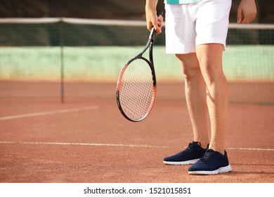 Young Man Playing Tennis On Court