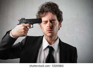 Young Man Pointing A Gun At His Head