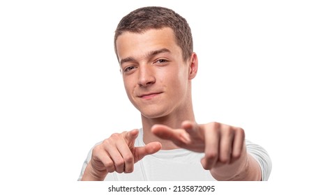 Young man points forward with his fingers. On a white background.