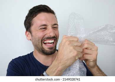 Young Man Popping Plastic Bubble Wrap