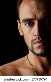 Young Man Portrait Half Face With Scar On Black Background