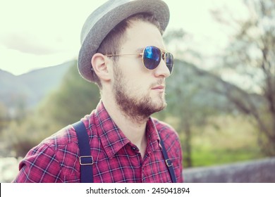 Young man posing on aged bridge