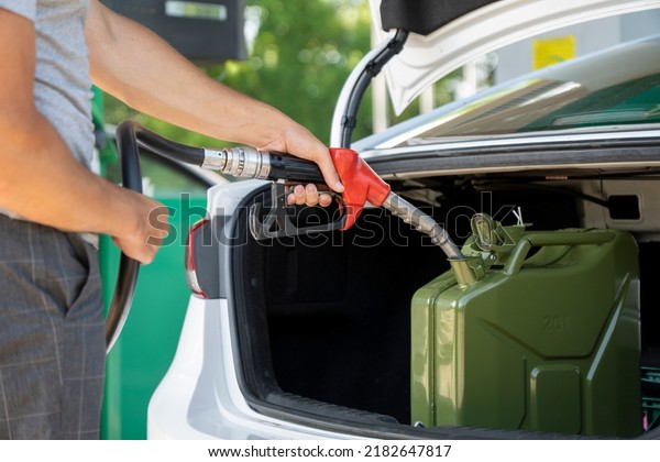 A young
man pours gasoline into the gas tank of a white car.A young man
pumps gasoline into a gas tank. Fuel and oil crisis. The concept of
gasoline prices and the oil
crisis.