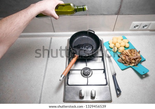 Young Man Pours Oil Into Heated Stock Photo Edit Now 1329456539