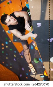 Young Man Practicing Top Rope Climbing In Indoor Climbing Gym, Hands In Focus