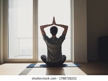 Young Man Practicing Yoga At Home. Men Doing Exercise And Meditating, Workout, Recreation, Self Care, Training, Fitness, Breathing, Relaxation, Healthy Lifestyle Concept