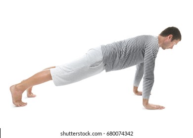 Young Man Practicing Yoga On White Background