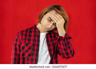 Young Man Prep Student With Long Hair. Portrait Of Depressing Guy. Red Background.