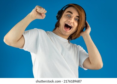 Young Man Prep Student With Long Hair. Portrait Of A Guy Music Lover With Headphones.