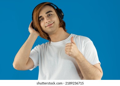 Young Man Prep Student With Long Hair. Portrait Of A Guy Music Lover With Headphones.