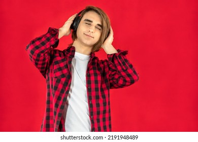 Young Man Prep Student With Long Hair. Portrait Of A Guy Music Lover With Headphones.