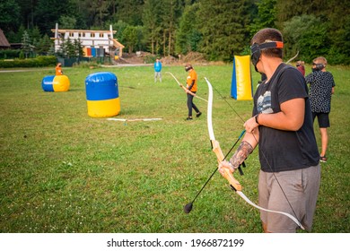 Young Man Preparing For An Attack While Playing Archery Tag