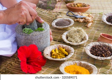 A Young Man Preparing Ayurvedic Medicine In The Traditional Manner In India
