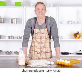 A Young Man Preparing Food In The Kitchen Baking A Home