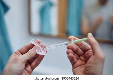 Young Man Preparing Silicon Tray For Teeth Whitening And Bleaching Gel Syringe. Themes Dental Health, Care And Beauty. 