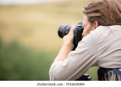 Young Man With Professional Camera Photographing The Beautiful Landscape