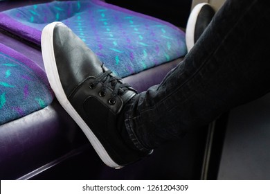 A Young Man Puts His Feet On The Seat Of A Bus To Rest, Putting His Feet Up On The First Bus Service In Hanley, Stoke On Trent, Staffordshire