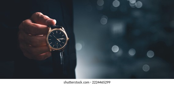 young man puts on a wristwatch - Powered by Shutterstock