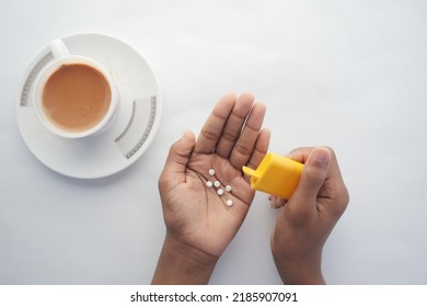 young man putting artificial sweetener in tea, - Shutterstock ID 2185907091