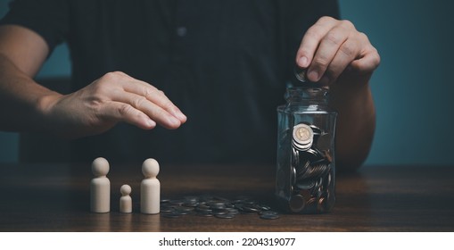 Young Man Putting Coin In To Jar, Saving, Charity, Family Finance Plan Concept, Fundraising, Superannuation, Investment, Financial Crisis Concept.
