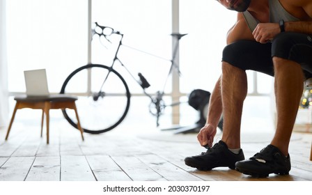 Young Man Putting On Sports Shoes At Home