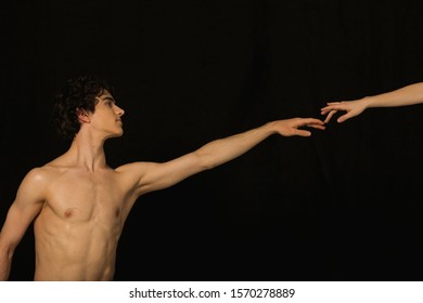 A Young Man Reaching Out To Touch Another's Hand