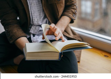 Young man reading a book - Shutterstock ID 244451953