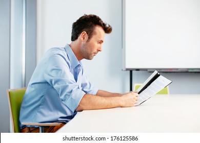 Young Man Reading A Contract