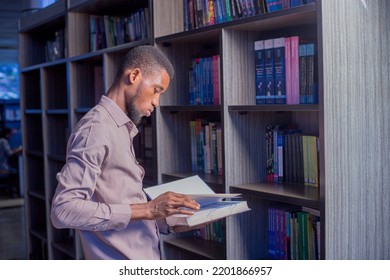 A young man reading in the library