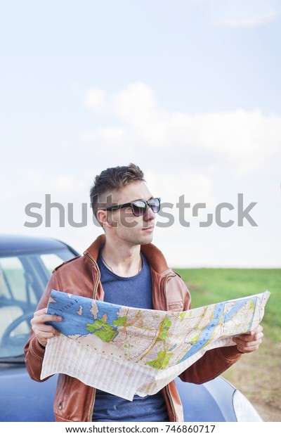 Young man reading road\
map
