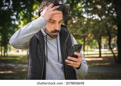 The young man received a very bad and disturbing message on his mobile phone. He is very stunned and shocked and can't believe what he saw