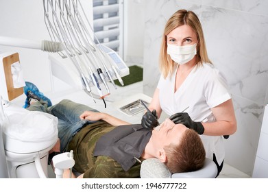 Young man receiving orthodontic treatment in dental office. - Shutterstock ID 1946777722